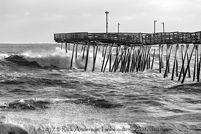 Wave crashing into an icy Avalon Pier