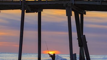 Surf Fisherman Casting at Sunset
