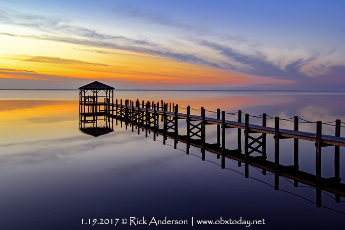 Dock in Duck, NC reflecting on a calm evening.