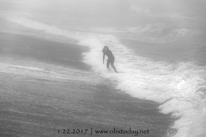 Skimboarder on a Foggy Winter Day at Kitty Hawk Pier